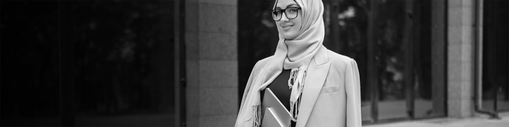 modern stylish muslim woman hijab business style jacket black abaya walking city street with laptop